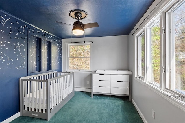 bedroom with carpet floors, baseboards, and a nursery area