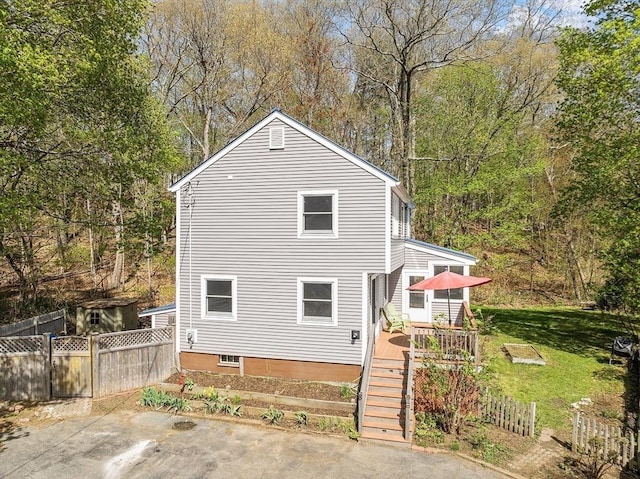 exterior space with fence, stairs, and a deck