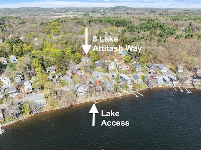 birds eye view of property with a water view, a view of trees, and a residential view