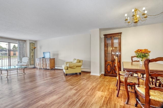 dining room featuring light hardwood / wood-style floors, a textured ceiling, a baseboard radiator, and a chandelier