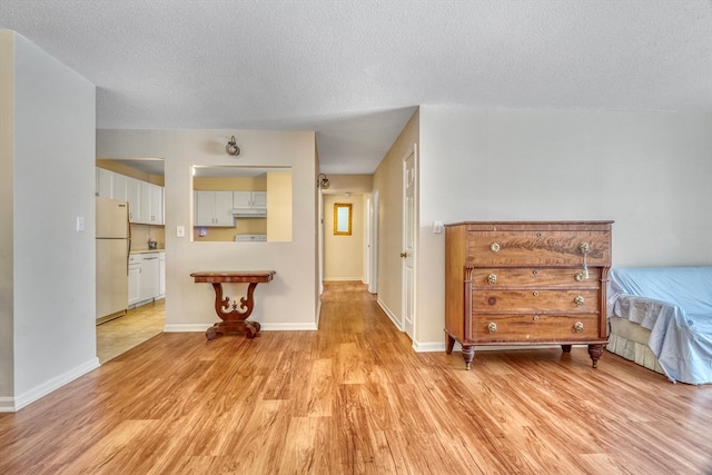 interior space with light hardwood / wood-style flooring and a textured ceiling