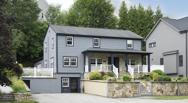 28 Ridge St, Arlington, MA 02474 - view of front facade with a porch, stone siding, stairs, and a shingled roof