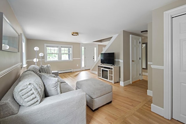 28 Ridge St, Arlington, MA 02474 - living area featuring a baseboard heating unit and light wood-type flooring