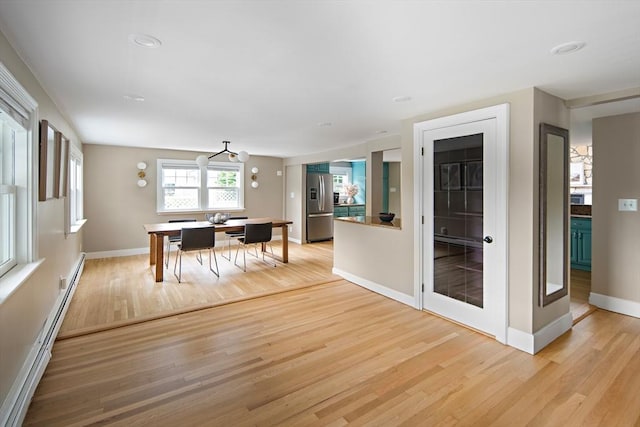 28 Ridge St, Arlington, MA 02474 - dining space featuring a baseboard radiator and light wood-type flooring