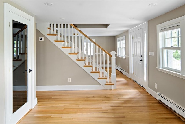28 Ridge St, Arlington, MA 02474 - entrance foyer featuring a baseboard heating unit, wood finished floors, stairway, recessed lighting, and a baseboard radiator