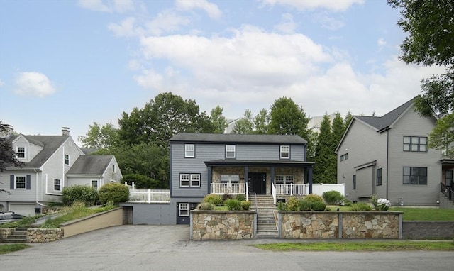 28 Ridge St, Arlington, MA 02474 - view of front of property featuring stairway, a porch, and a residential view