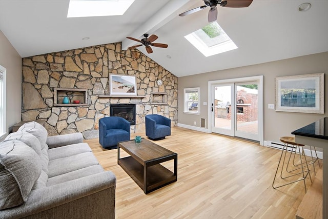 28 Ridge St, Arlington, MA 02474 - living area featuring a skylight, a ceiling fan, light wood-style floors, and a fireplace
