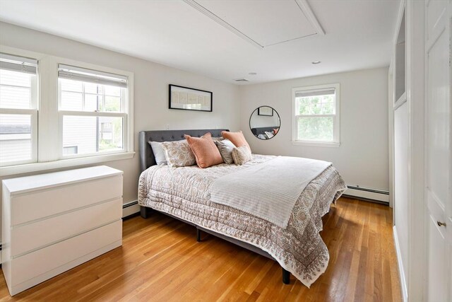 28 Ridge St, Arlington, MA 02474 - bedroom featuring a baseboard radiator and light wood finished floors