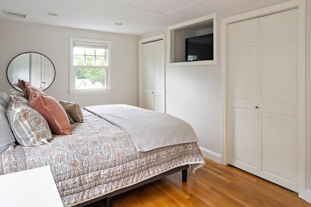 28 Ridge St, Arlington, MA 02474 - bedroom featuring two closets and light wood-style floors