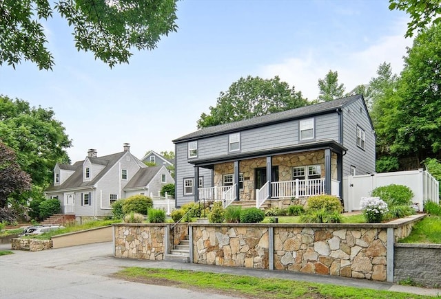 28 Ridge St, Arlington, MA 02474 - view of front of house with a porch, stone siding, and stairs
