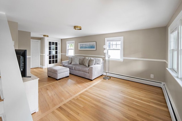 28 Ridge St, Arlington, MA 02474 - living area featuring baseboard heating and wood finished floors