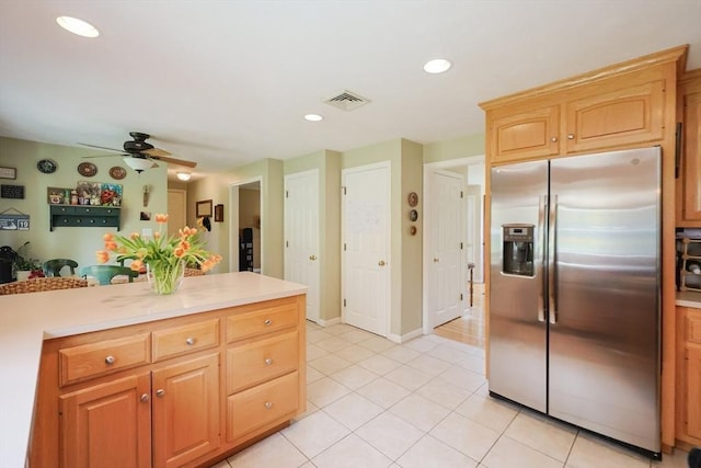 kitchen featuring visible vents, light tile patterned flooring, ceiling fan, stainless steel refrigerator with ice dispenser, and light countertops