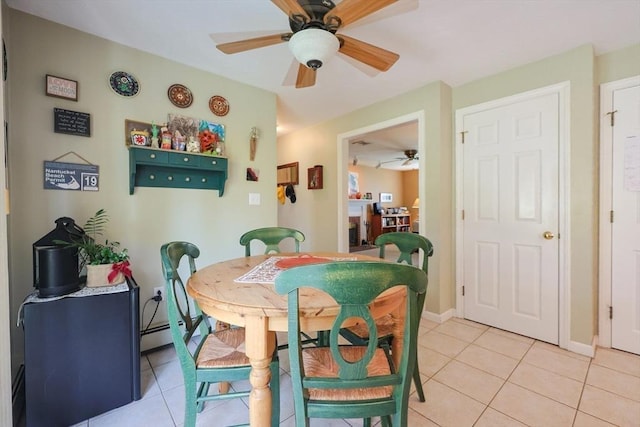 dining area with baseboards, a ceiling fan, and light tile patterned flooring