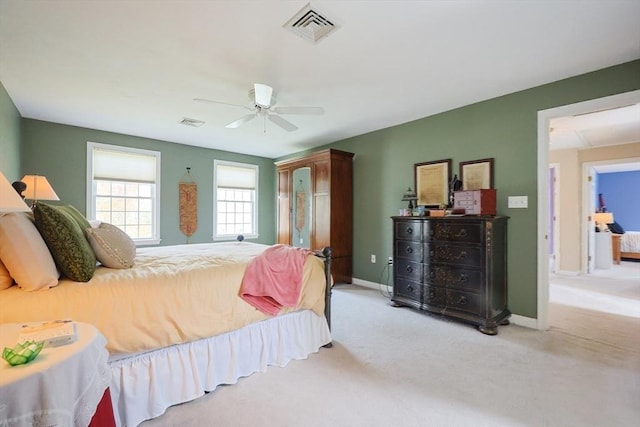 carpeted bedroom with baseboards, ceiling fan, and visible vents