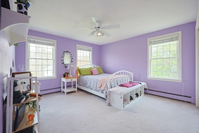 bedroom with carpet flooring, ceiling fan, and baseboard heating