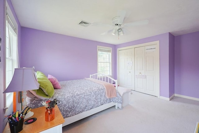 carpeted bedroom featuring visible vents, baseboards, ceiling fan, and a closet