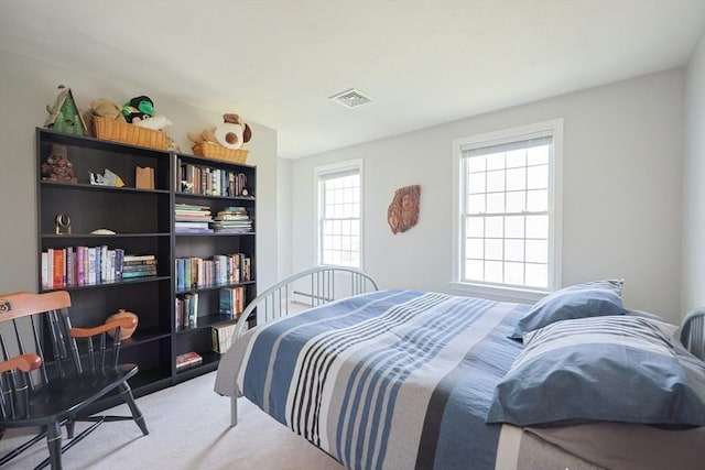 carpeted bedroom with visible vents