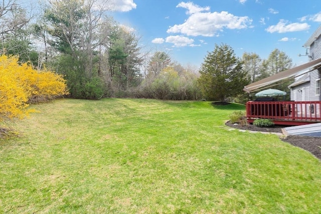 view of yard with a wooden deck
