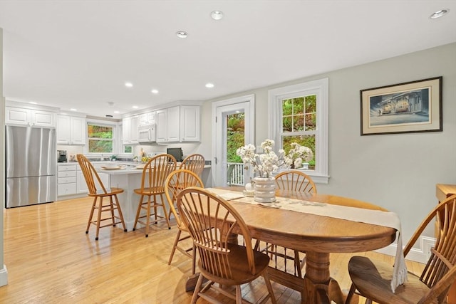 dining area featuring light wood-type flooring and recessed lighting