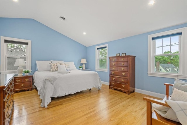 bedroom featuring multiple windows, vaulted ceiling, light wood finished floors, recessed lighting, and baseboards