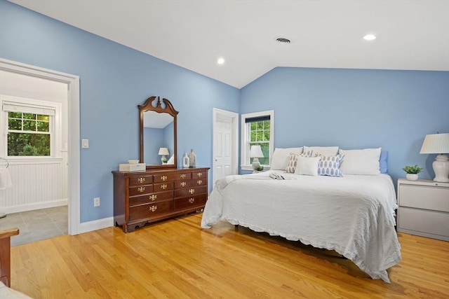 bedroom with light wood-type flooring, lofted ceiling, baseboards, and recessed lighting