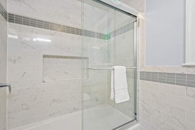 full bathroom with tiled shower