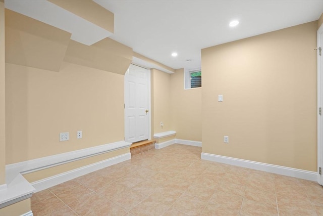 finished below grade area featuring recessed lighting, baseboards, and light tile patterned floors