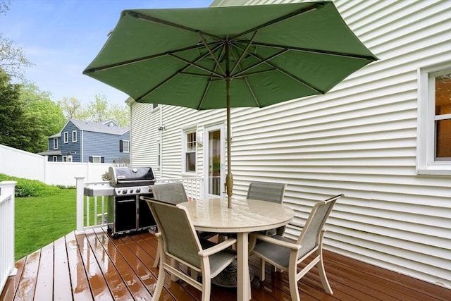 deck featuring grilling area and outdoor dining space