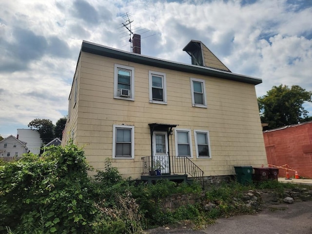 colonial house featuring a chimney