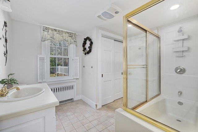 bathroom featuring tile patterned flooring, vanity, radiator heating unit, and a shower with door