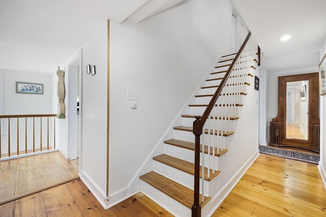 stairway featuring wood-type flooring