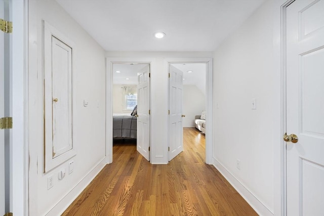 hallway with light hardwood / wood-style flooring