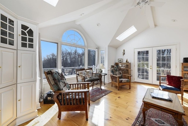 sunroom / solarium with ceiling fan, lofted ceiling with skylight, and french doors