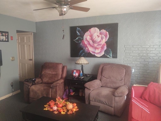 sitting room with ceiling fan and carpet