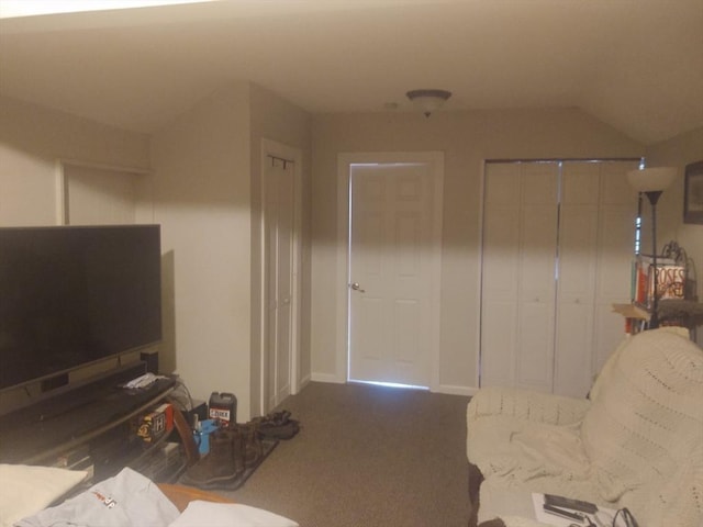 carpeted living room featuring vaulted ceiling