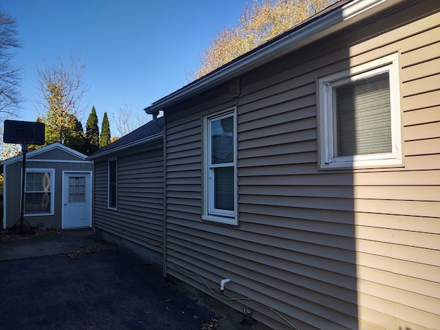 view of side of home featuring a shed