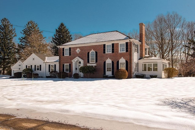 view of front of house with brick siding and a chimney