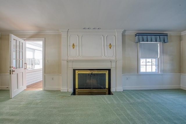 unfurnished living room featuring carpet floors, ornamental molding, and a fireplace with flush hearth