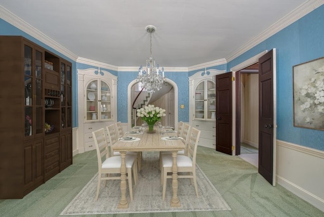 dining area with stairs, ornamental molding, arched walkways, and light colored carpet