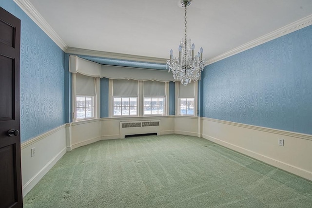 empty room featuring carpet floors, a wainscoted wall, radiator heating unit, and ornamental molding