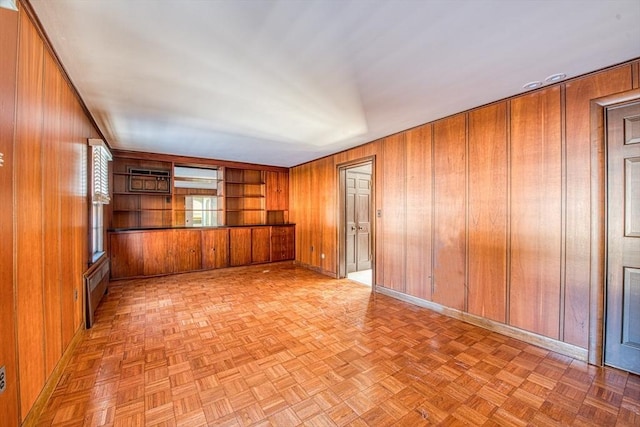 interior space with wood walls and baseboards