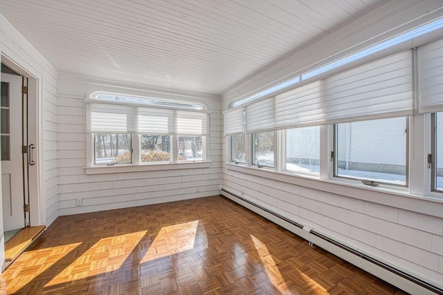 unfurnished sunroom featuring baseboard heating