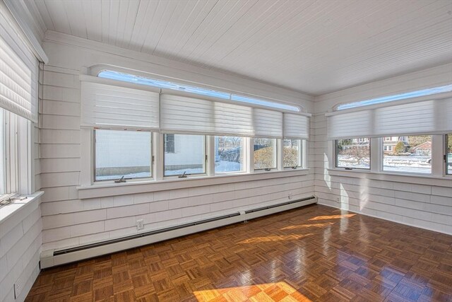 unfurnished sunroom featuring a baseboard heating unit