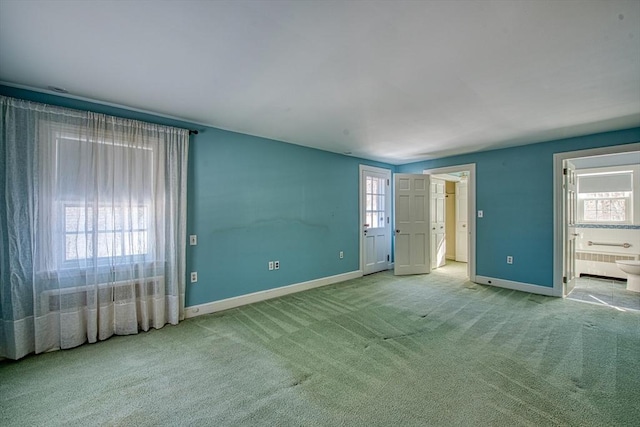 spare room featuring carpet floors, radiator heating unit, and baseboards