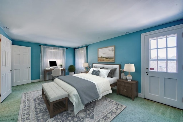 carpeted bedroom featuring baseboards