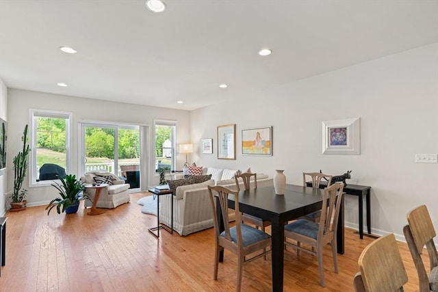 dining room with recessed lighting, light wood finished floors, and baseboards