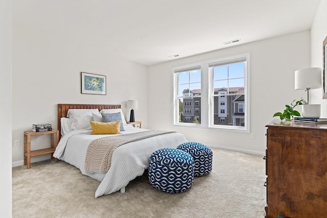 bedroom featuring carpet and baseboards
