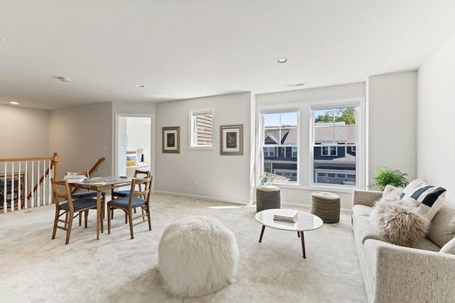 living room featuring light carpet and recessed lighting