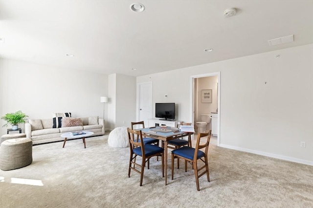 dining space featuring light carpet, recessed lighting, and baseboards