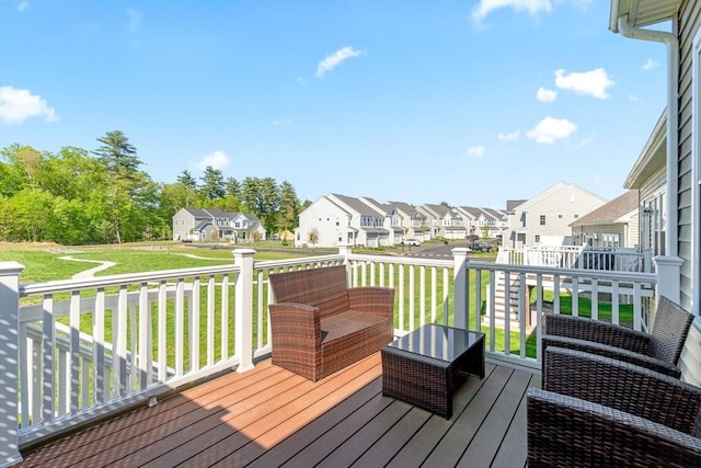 deck featuring a residential view and a yard